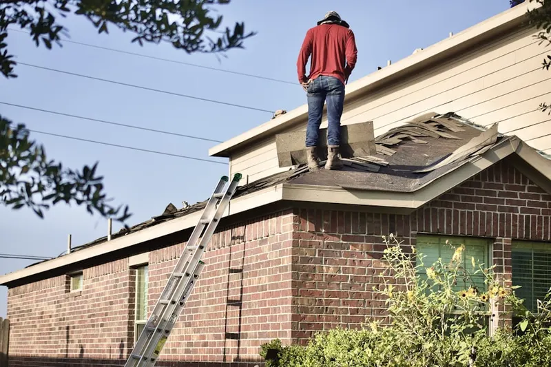 Professional roofer working on a residential roof in Stickney